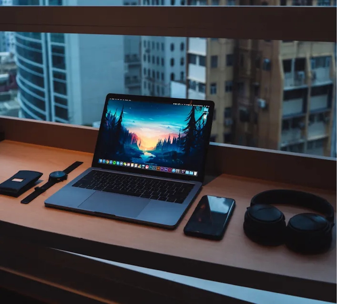 Laptop on desk with cityscape view